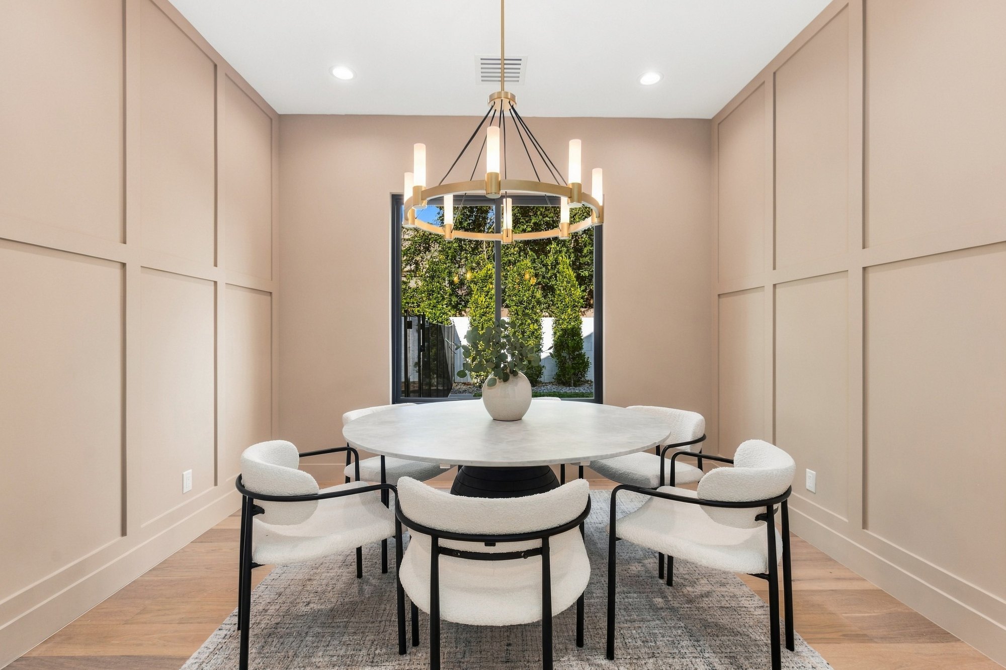 Dining room with a round table under a brass chandelier